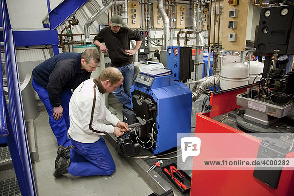 Master craftman students working on a heater  master course for heating  ventilating  and air conditioning  HVAC  in the Master Craftman School of the Chamber of Small Industries and Skilled Trades  Dusseldorf  North Rhine-Westphalia  Germany  Europe
