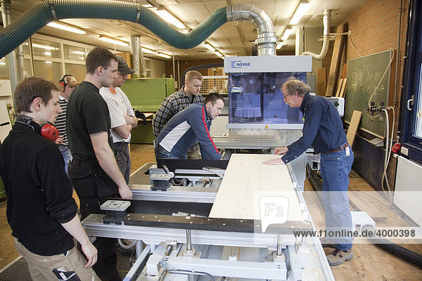 Specialist lecturer demonstrating a computer numerical control (CNC) milling machine  Master Craftman School of the Chamber of Small Industries and Skilled Trades for carpentry  Dusseldorf  North Rhine-Westphalia  Germany  Europe