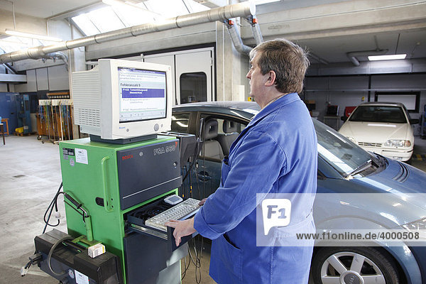 Master Craftsman of motor vehicle mechanics and lecturer of the Master Craftmans School of the Chamber of Small Industries and Skilled Trades performing a diagnostics test on a car  Dusseldorf  North Rhine-Westphalia  Germany  Europe