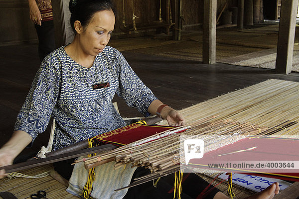 Woman on a loom in the Sarawak Cultural Village near Kuching  Sarawak  Borneo  Malaysia  Southeast Asia