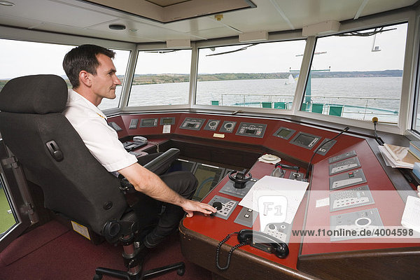 Captain Pasztor Zoltan in the steering cabin of the MS Amadeus Royal cruise ship  navigating his ship on her cruise on the Danube near Turnu-Severin  Romania