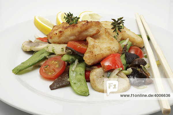 Pangasius filet on a bed of Asian vegetables