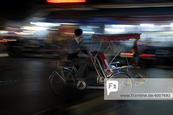 Motion blur  Cycle rickshaw in the city lights at night  Hanoi  Vietnam  Southeast Asia