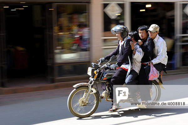 Four Vietnames people on a moped  Sapa  Hanoi  North Vietnam  Southeast Asia