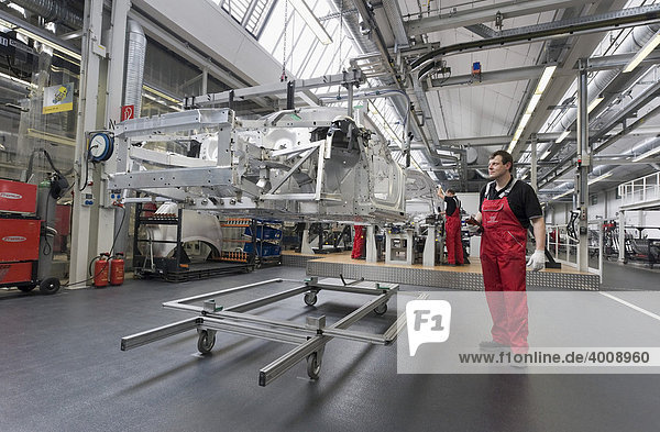 Audi employees assembling the frame of an Audi R8 sports car in the Audi R8 assembly hall  Baden-Wuerttemberg  Germany  Europe