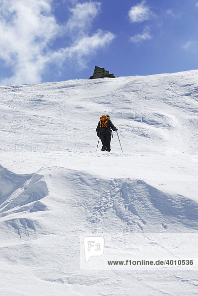 Mountaineer  ski tourer ascending the summit in snowy terrain  Glungezer Tuxer  Alps  Tyrol  Austria