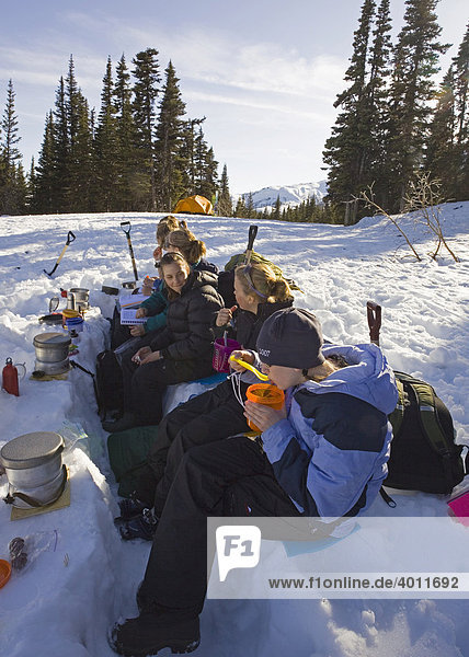 Group of children practising cooking skills for winter camping  Yukon outdoor school program  White Pass  Chilkoot Pass  Chilkoot Trail  British Columbia  B.C.  Canada