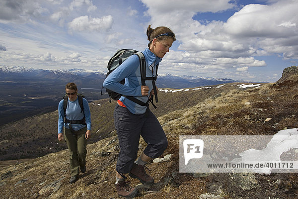Two young woman hiking  Mt. Lorne  Mountains  Pacific Coast Ranges behind  Yukon Territory  Canada  North America