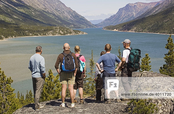 Group of hikers enjoying view over Lake Bennett  Chilkoot Pass  Chilkoot Trail  Yukon Territory  British Columbia  B. C.  Canada