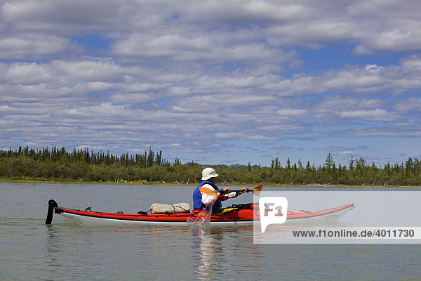 Man paddling a sea kayak on Yukon River near Lake Laberge  Yukon Territory  Canada