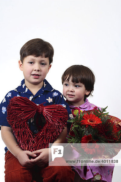 Boy  6  and girl  2  holding flowers and a red heart