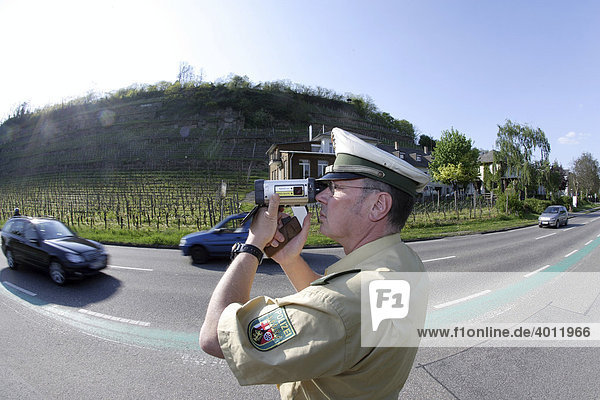A police officer doing speed monitoring with a laser gun  Koblenz  Rhineland-Palatinate  Germany  Europe