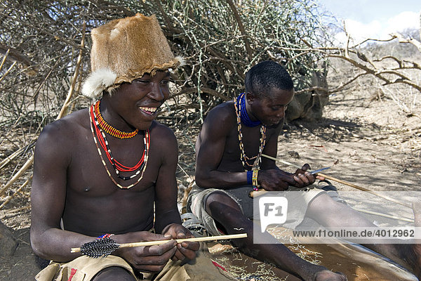Members of the Hadzabe tribe making a hunting arrow  Lake Eyasi  Tanzania  Africa