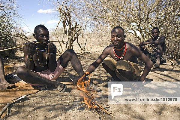Men of the Hadzabe tribe are making hunting arrows  Lake Eyasi  Tanzania  Africa