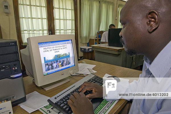 HIV AIDS programme coordinator of a company working at his computer  Quelimane  Mozambique  Africa