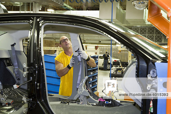 A member of the United Auto Workers union assembles the Chrysler Sebring sedan at Chrysler's Sterling Heights Assembly Plant  here a worker installs a seat belt module  Sterling Heights  Michigan  USA
