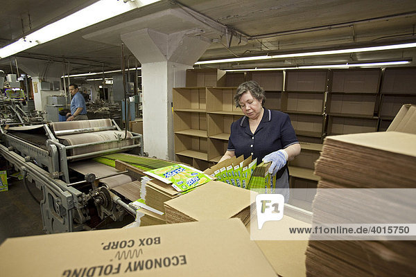 A worker at Economy Folding Box Corporation  which makes containers for retail products  Chicago  Illinois  USA