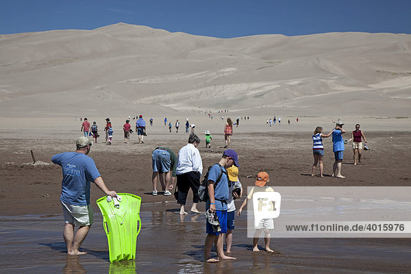 Vacationers along Medano Creek in Great Sand Dunes National Park  Mosca  Colorado  USA