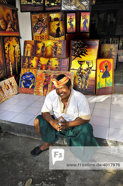 Artist sitting in front of a studio near Ubud  Bali  Indonesia