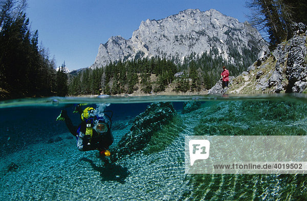 Diver in the Gruener See Lake being watched by a woman on the shore  Tragoess  Styria  Austria  Europe
