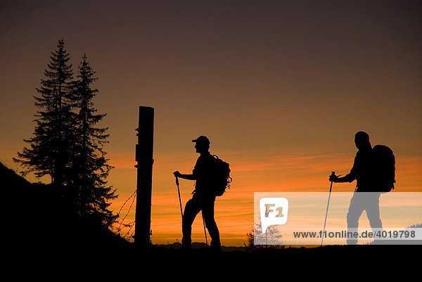 Silhouettes of two hikers  hiking tour in the evening  Styria  Austria  Europe