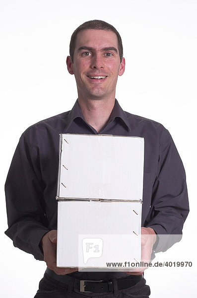 Man smiling as he carries two parcel boxes