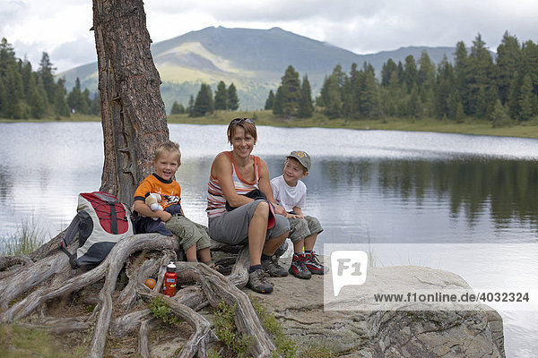 Woman and two children at the Gruensee Lake  Turracher Hoehe  Nockberge Mountains  Carinthia  Austria  Europe