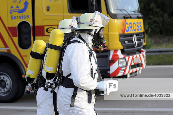 Firefighters wearing protective clothing during rescue work after a freight lorry accident on the A8 motorway  Aichelberg  Baden-Wuerttemberg  Germany  Europe