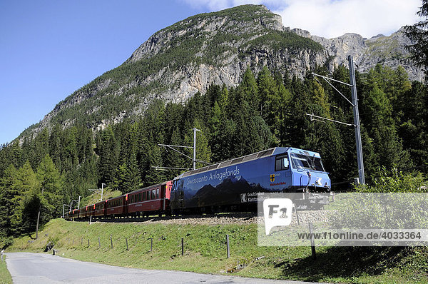 A passenger train of the Rhaetische Bahn RhB Railway travelling on the stretch between Berguen and Preda Graubuenden Switzerland Europe