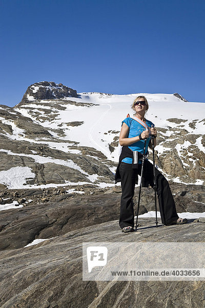 Woman with Nordic Walking Sticks on her way to the Oberwalder Huette Mountain Hut  Hohe Tauern National Park  Carinthia  Austria  Europe