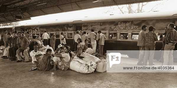 Indian people waiting for a train in a railway station  Chittorgah  India  South Asia
