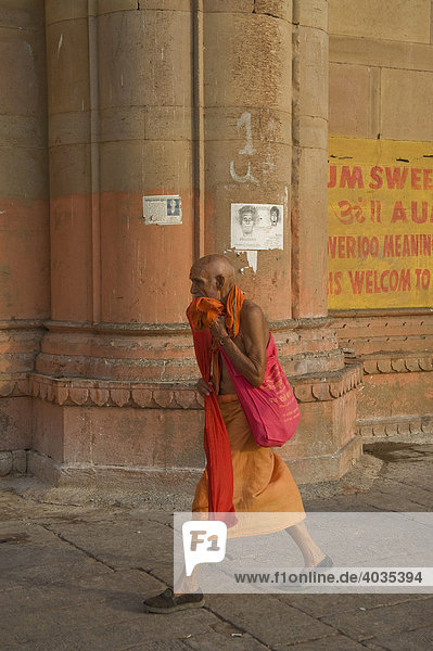 Indian man walking on a ghat  Varanasi  Benares  Uttar Pradesh  India  South Asia