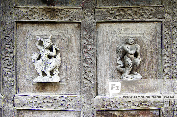 Carved figures on a teak door  Monastery Shwe In Bin Kyaung  Mandalay  Burma  Myanmar  Southeast Asia
