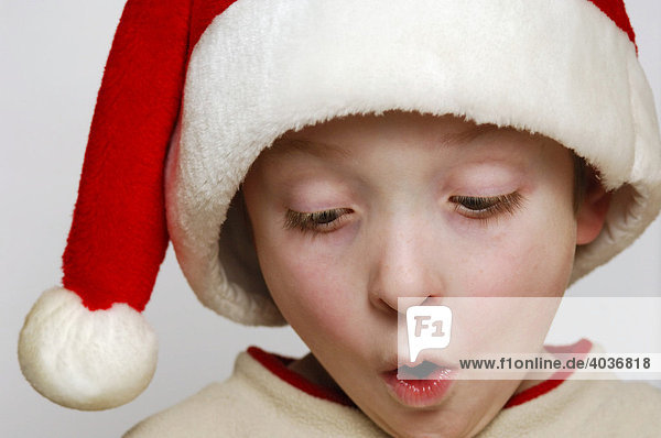 Young boy surprised and excited  opening up his Christmas present