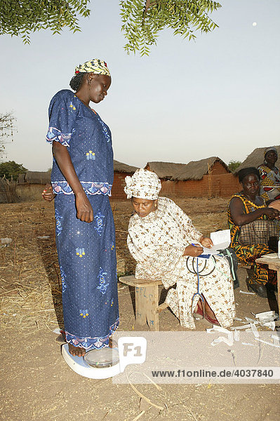 Pregnant woman on a weighing scale at a preventive medical examination  Houssere Faourou  Cameroon  Africa