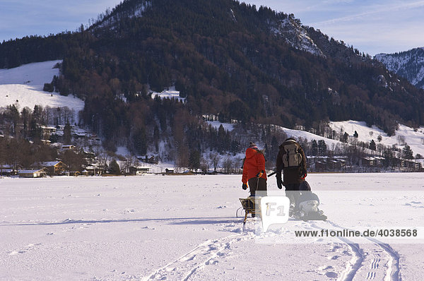 Hikers on the frozen Lake Schliersee  winter landscape  Bavaria  Germany  Europe