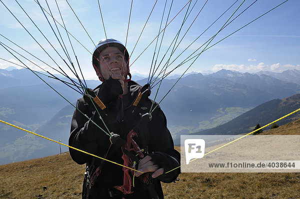 Paraglider preparing for takeoff  holding the lines  testing the wing in flight  Monte Cavallo  Sterzing  Province of Bolzano-Bozen  Italy  Europe