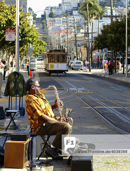 Street musician playing saxophone  streetcar stop  San Francisco  California  USA