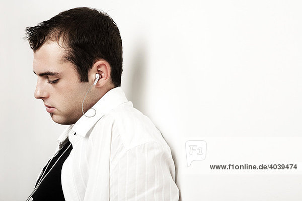 Young man listening to music with earphones