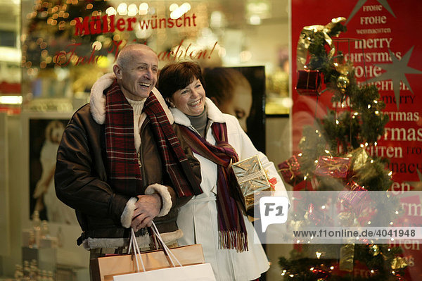 Old-aged couple doing Christmas shopping