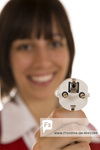 Twenty-year-old woman holding an electric plug