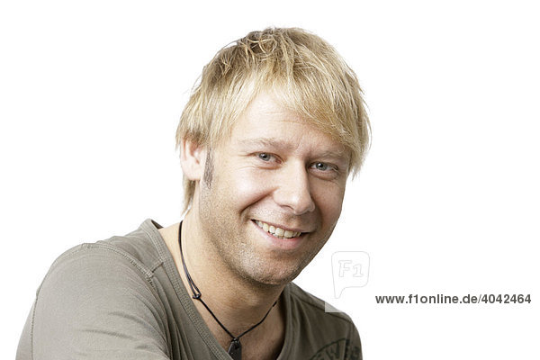 Blonde man wearing a T-shirt  looking into the camera  smiling  portrait