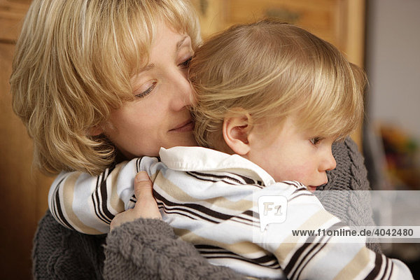 Blonde Mutter umarmt 2-jährigen Jungen