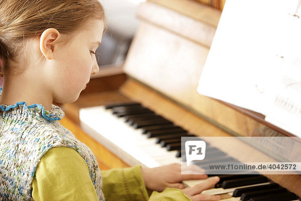 Girl  8 years old  playing piano