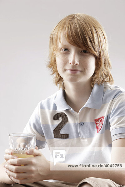 12-jähriger Junge mit Saftglas