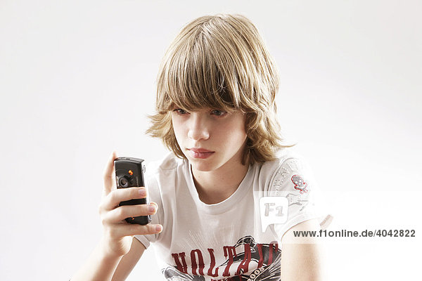 12 year-old boy playing with his cellphone