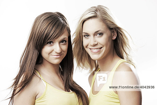 Two young women wearing yellow tops