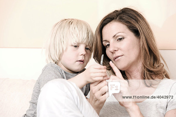Mother and son looking at a pocket knife