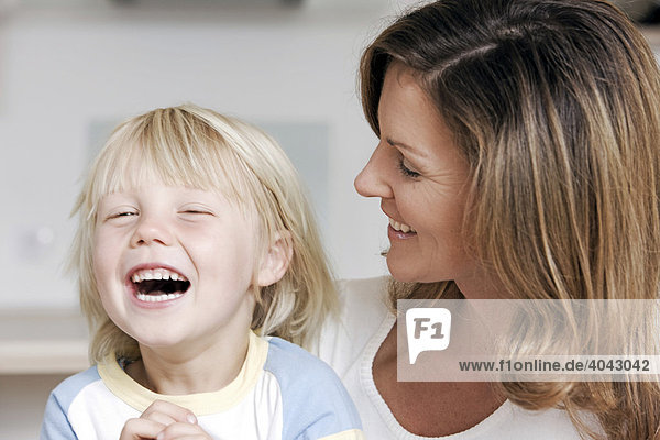 Blonde son and mother laughing