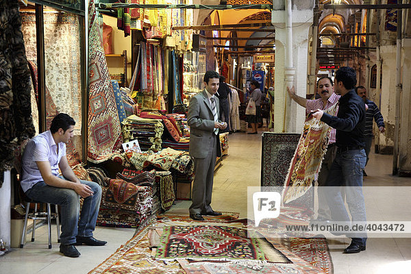 Rug merchant at the Grand Bazaar or Covered Bazaar  covered market consisting of numerous vaults with goods of all sorts  Istanbul  Turkey
